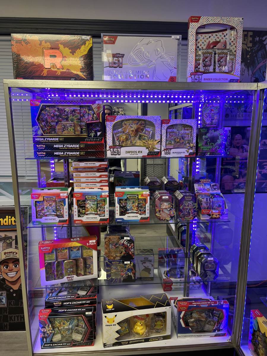 Sealed trading card product in glass cases at Hard Hittin' Cards Southington